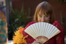 Ally Thomas offering tantric massage in Adelaide in an elegant red outfit with a traditional fan. Ally Thomas offering tantric massage in Adelaide in an elegant red outfit with a traditional fan.