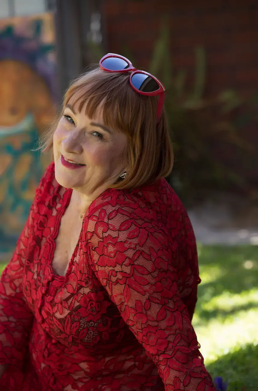 Ally Thomas, tantric massage practitioner in Adelaide, smiling in a red lace top Ally Thomas, tantric massage practitioner in Adelaide, smiling in a red lace top