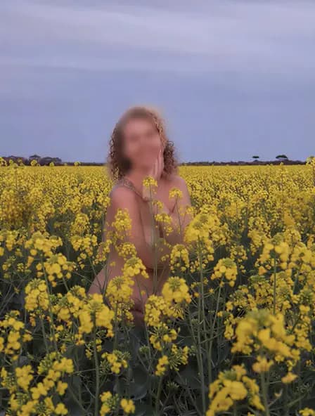 Erotic massage Melbourne, masseuse Alice outdoors in a yellow flower field at dusk Erotic massage Melbourne, masseuse Alice outdoors in a yellow flower field at dusk