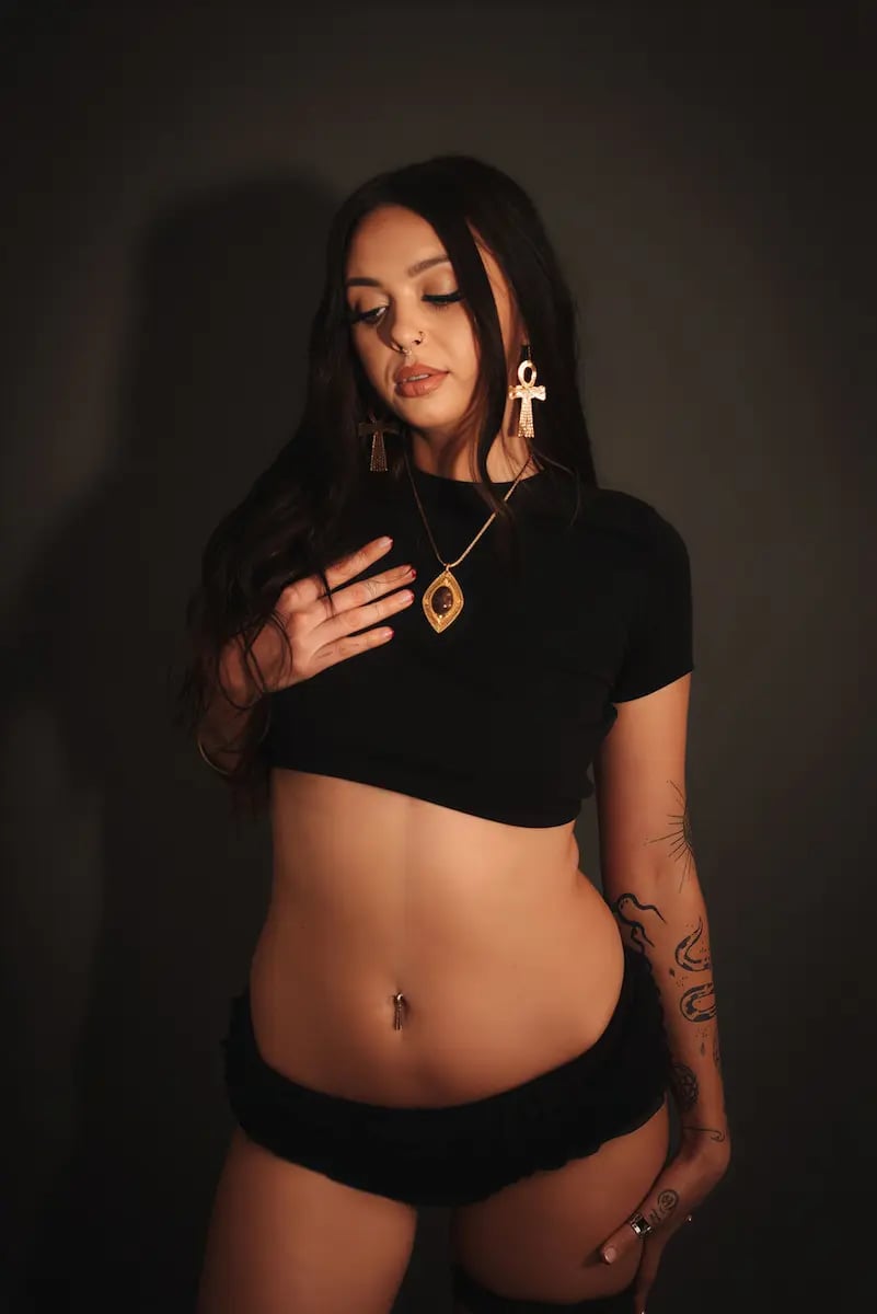 Outcall massage Melbourne, tattooed masseuse in black with gold ankh jewellery Outcall massage Melbourne, tattooed masseuse in black with gold ankh jewellery