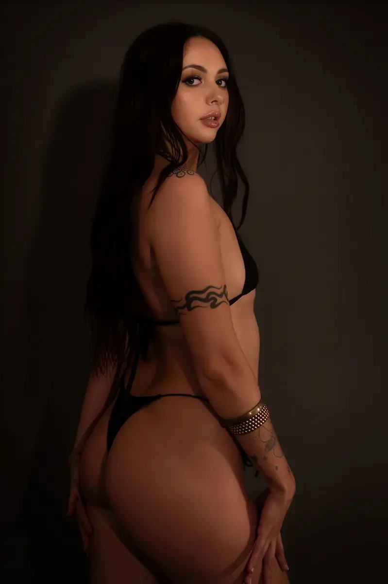 Sensual massage Melbourne, tattooed masseuse looking back over her shoulder Sensual massage Melbourne, tattooed masseuse looking back over her shoulder