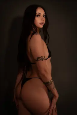 Sensual massage Melbourne, tattooed masseuse looking back over her shoulder Sensual massage Melbourne, tattooed masseuse looking back over her shoulder