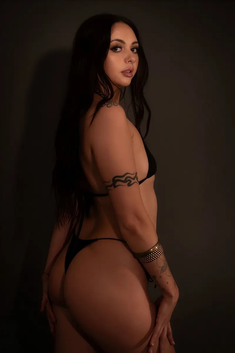 Sensual massage Melbourne, tattooed masseuse looking back over her shoulder Sensual massage Melbourne, tattooed masseuse looking back over her shoulder