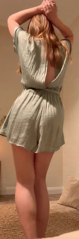 Tantra Melbourne, blonde woman seen from behind in an open back sage green playsuit with arms raised Tantra Melbourne, blonde woman seen from behind in an open back sage green playsuit with arms raised